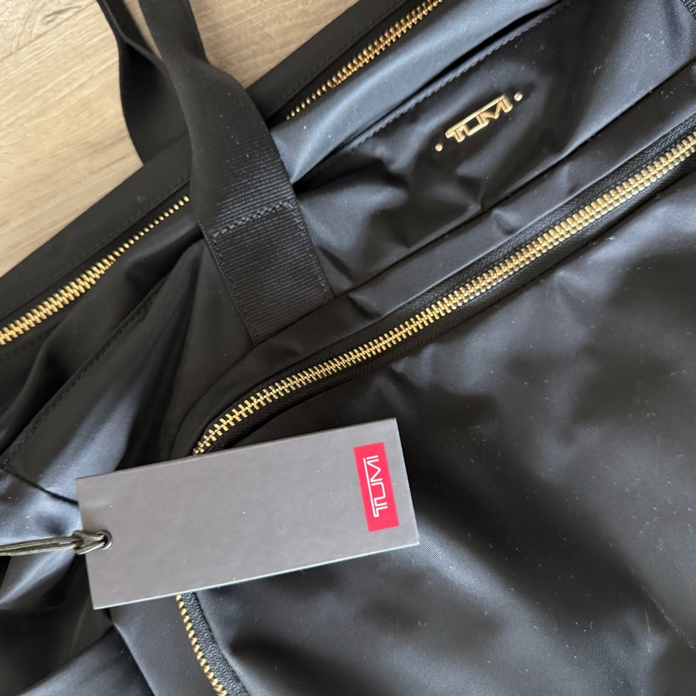 Tumi Black Travel Bag with Gold Accents